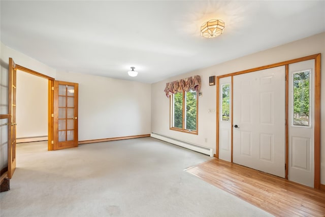 entrance foyer featuring light hardwood / wood-style floors, french doors, and a baseboard heating unit