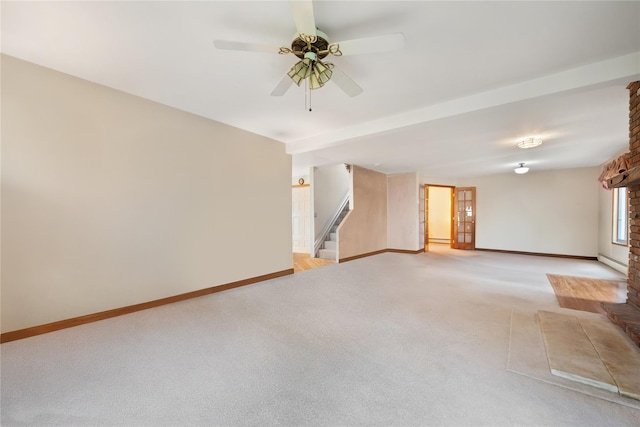 carpeted empty room featuring ceiling fan and a baseboard heating unit