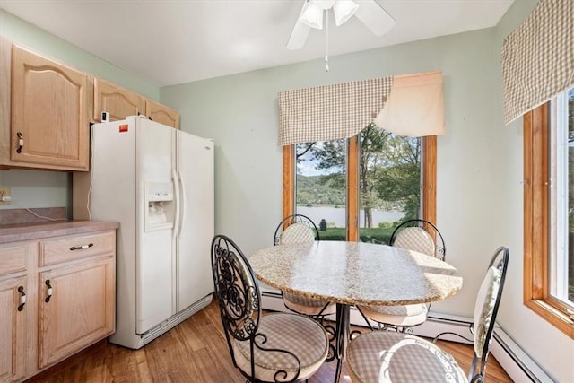 dining area featuring ceiling fan and light hardwood / wood-style floors