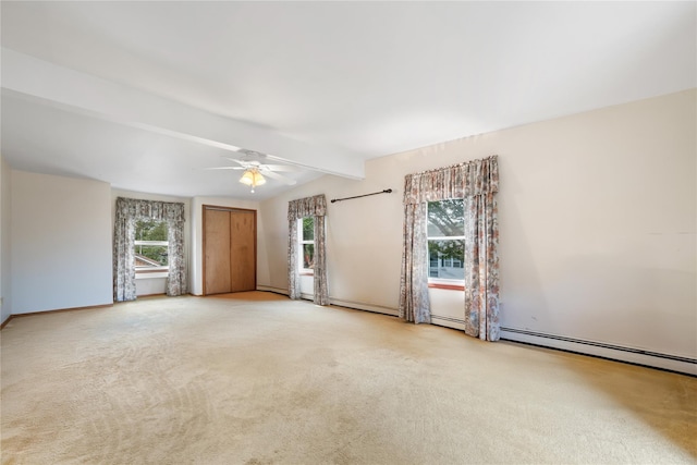 carpeted empty room with vaulted ceiling with beams, a healthy amount of sunlight, and ceiling fan