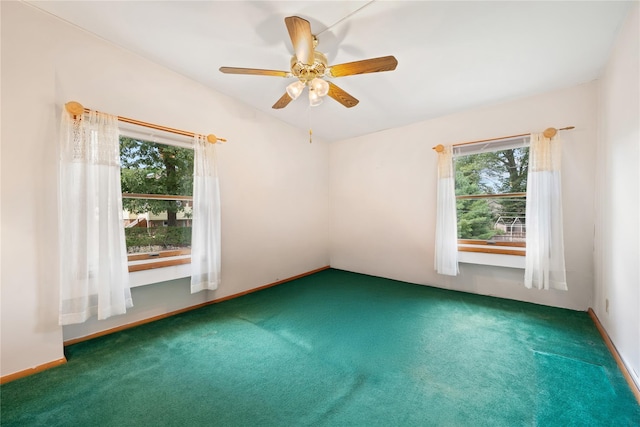 carpeted spare room featuring ceiling fan