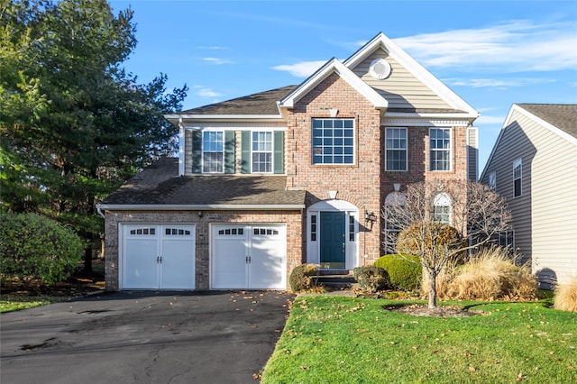 view of front of house with a garage and a front lawn