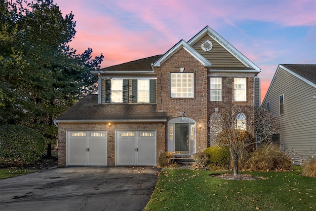 view of front of house featuring a lawn and a garage