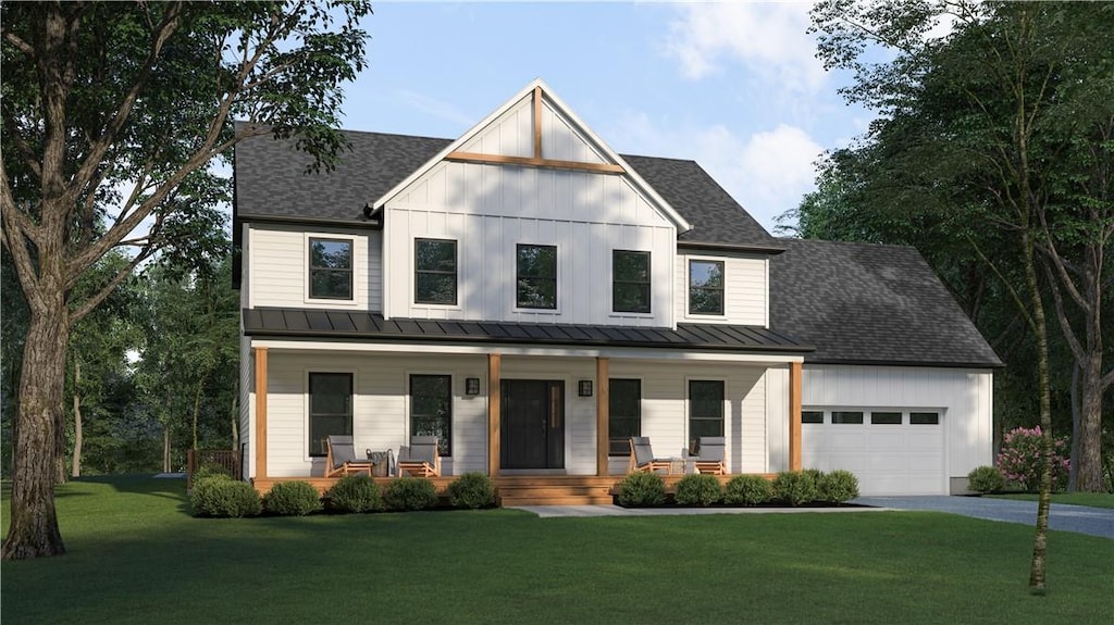 modern inspired farmhouse with a porch, a garage, and a front lawn