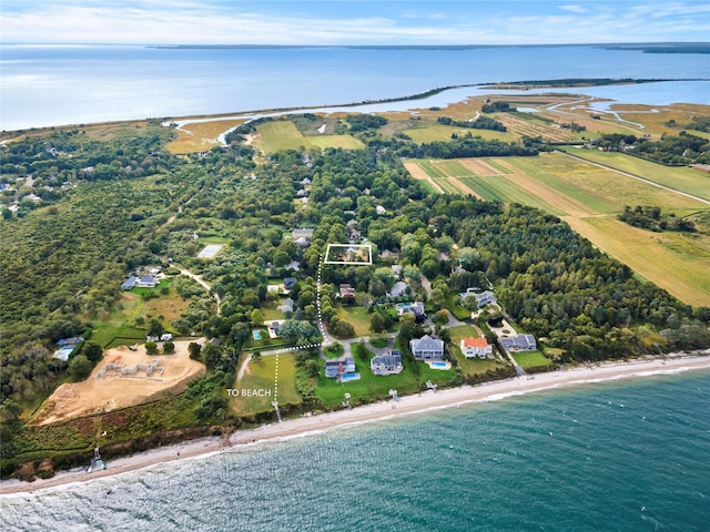 drone / aerial view with a water view and a beach view