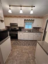 kitchen with pendant lighting, exhaust hood, sink, stainless steel range, and white cabinetry