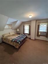 bedroom featuring lofted ceiling and carpet floors