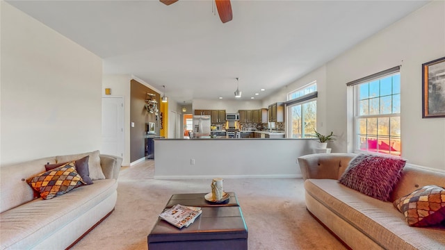 living room featuring ceiling fan and light colored carpet