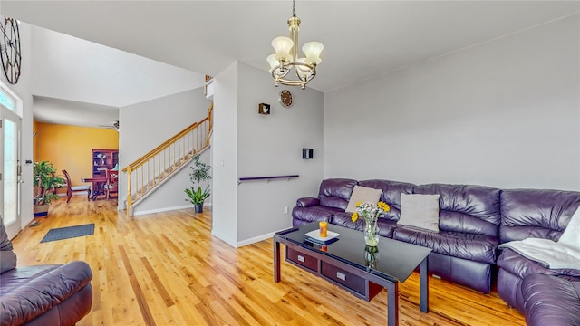 living room featuring light wood-type flooring and an inviting chandelier