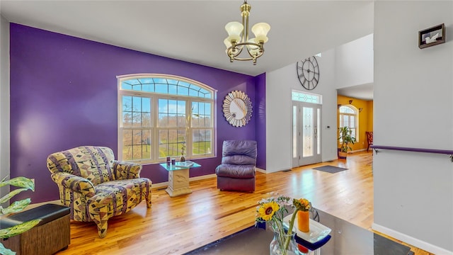 sitting room featuring light hardwood / wood-style flooring and a notable chandelier