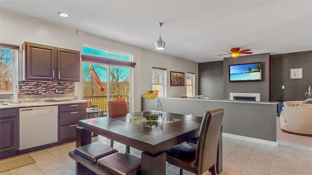 dining space featuring light tile patterned floors and ceiling fan