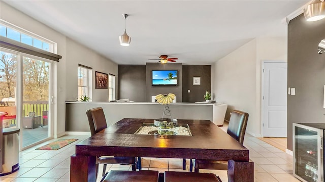 dining room with wine cooler, ceiling fan, and light tile patterned floors