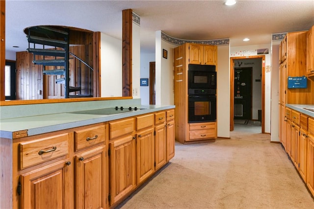 kitchen featuring light carpet, a textured ceiling, double oven, and electric stovetop