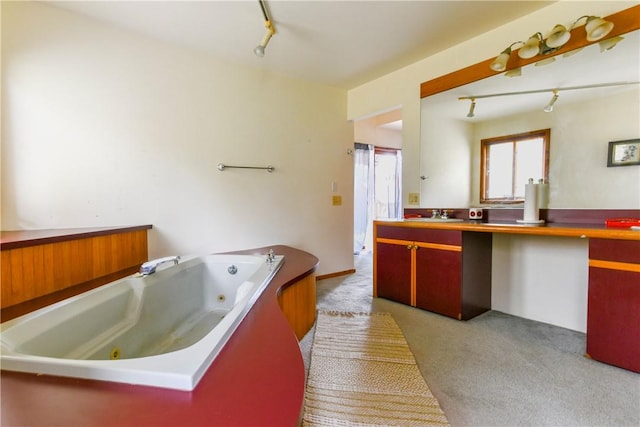 bathroom with vanity and a tub