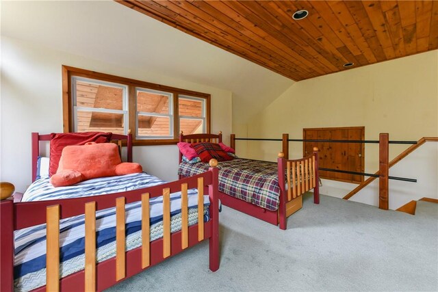 carpeted bedroom featuring vaulted ceiling and wooden ceiling