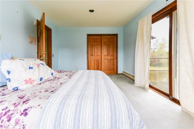 bedroom featuring carpet and a baseboard heating unit