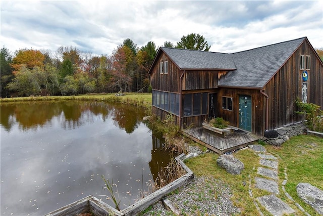 exterior space featuring a water view and a sunroom