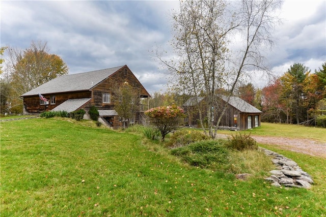 view of property exterior featuring a lawn and an outdoor structure