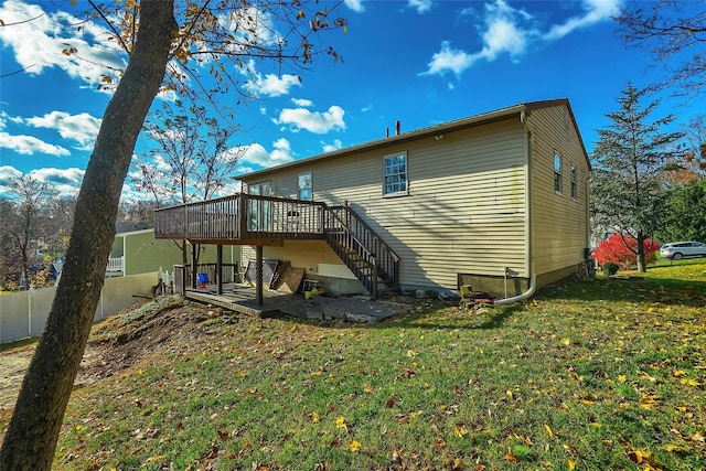 rear view of house featuring a deck and a yard