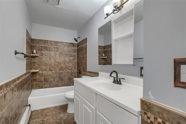 full bathroom with vanity, toilet, tiled shower / bath, and a baseboard heating unit