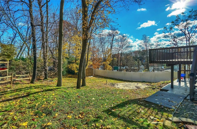 view of yard with a storage shed and a deck