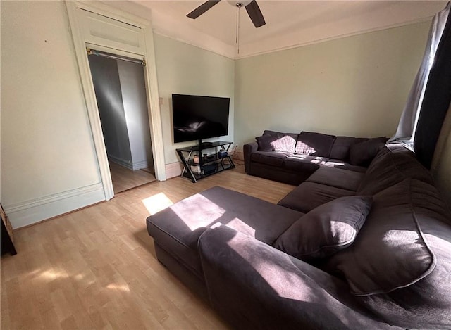 living room featuring ceiling fan and light hardwood / wood-style flooring