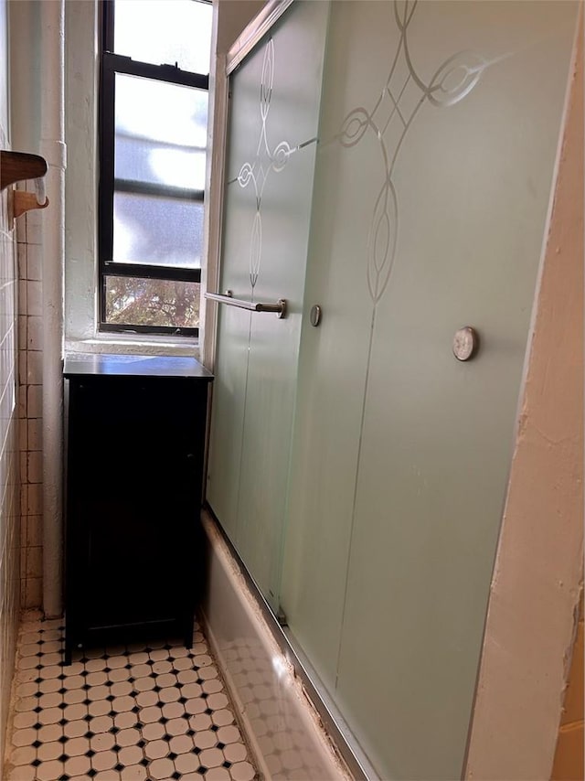 bathroom with vanity and shower / bath combination with glass door