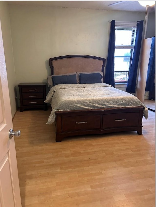 bedroom with light wood-type flooring and ceiling fan