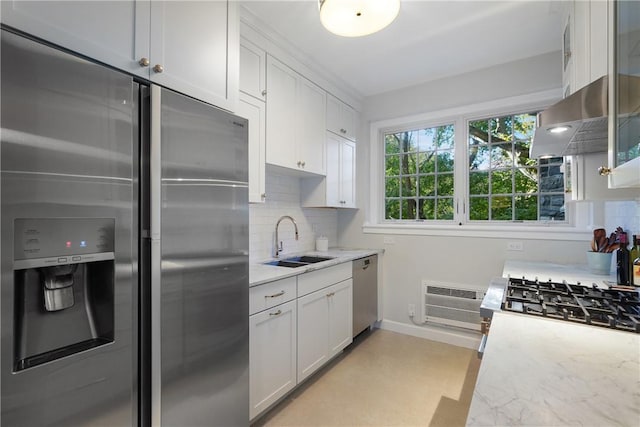 kitchen with appliances with stainless steel finishes, white cabinetry, tasteful backsplash, and sink