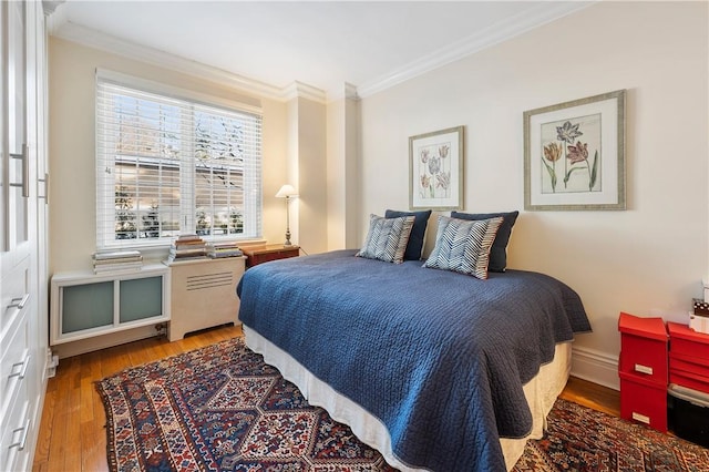 bedroom featuring wood-type flooring and ornamental molding