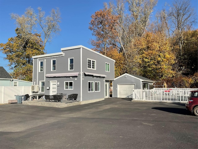 view of front of property featuring a garage and an outbuilding