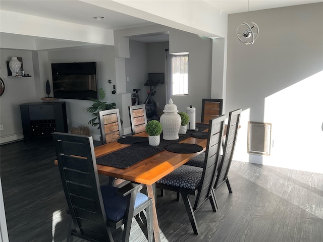 dining room featuring a chandelier, dark hardwood / wood-style floors, and a baseboard heating unit