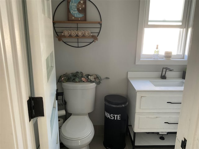 bathroom with tile patterned flooring, vanity, and toilet