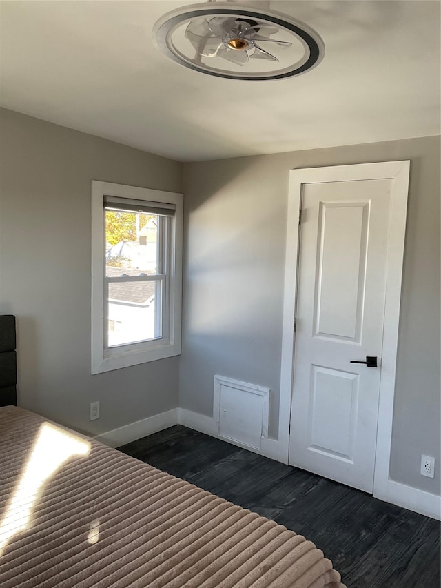 unfurnished bedroom with dark hardwood / wood-style flooring