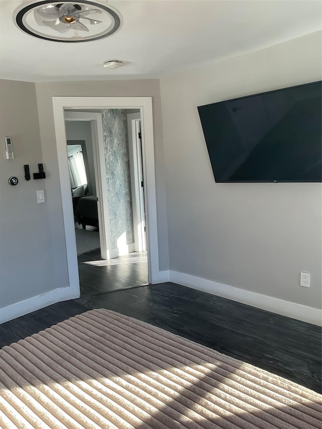 unfurnished bedroom featuring a closet and dark hardwood / wood-style floors