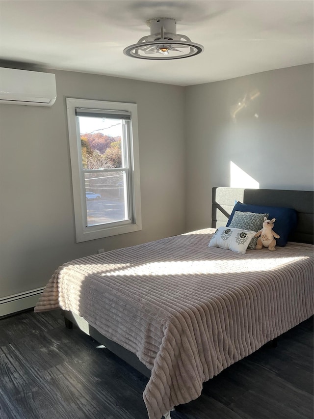 bedroom featuring a wall unit AC, dark hardwood / wood-style flooring, and baseboard heating