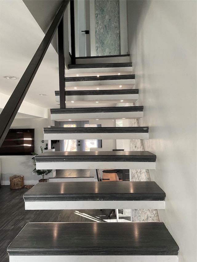 staircase featuring hardwood / wood-style flooring