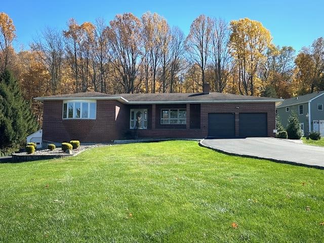 single story home with a garage and a front lawn