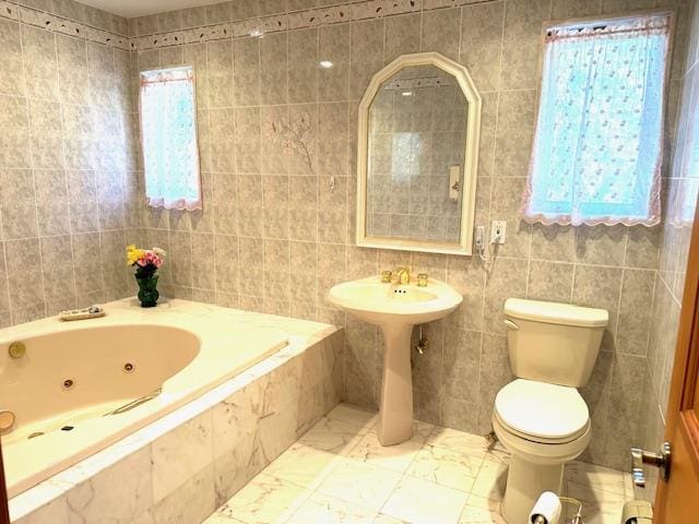 bathroom featuring tile walls and toilet