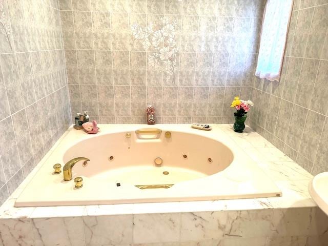 bathroom featuring tiled bath