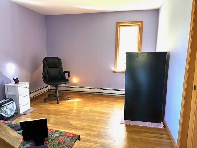 office space featuring light hardwood / wood-style flooring and a baseboard radiator