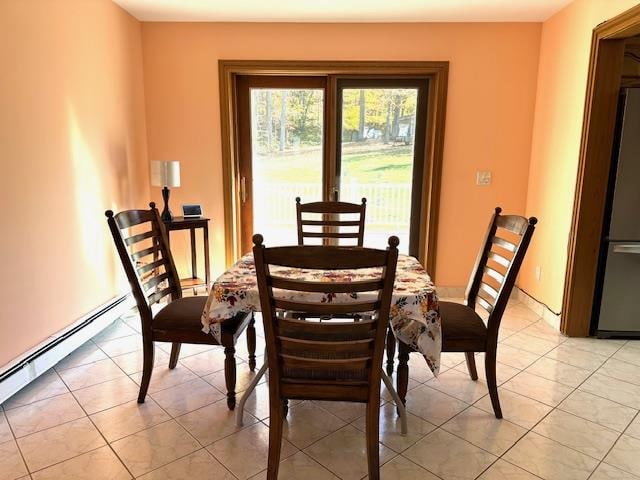 tiled dining area featuring baseboard heating