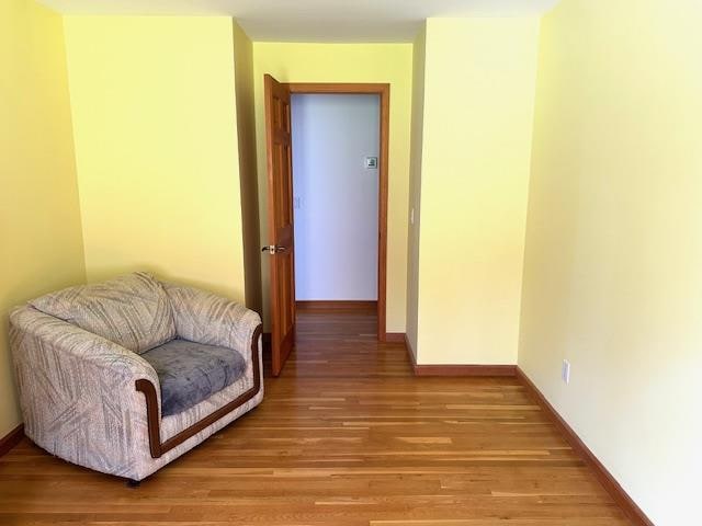 hall with hardwood / wood-style floors