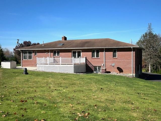 back of house featuring a yard and a storage shed