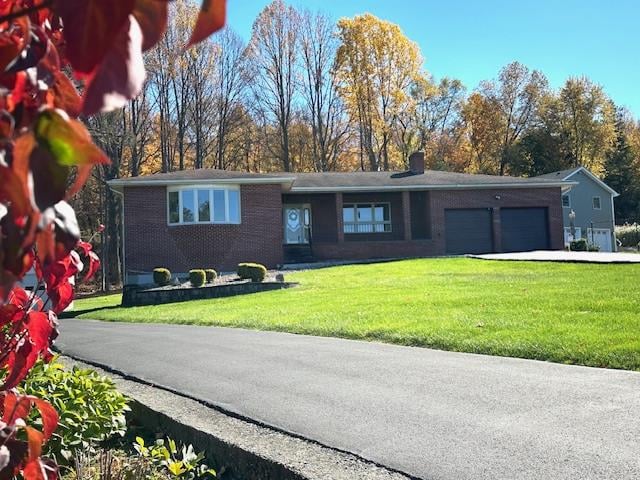 single story home featuring a front yard and a garage