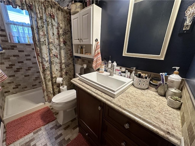 bathroom featuring curtained shower, vanity, and toilet