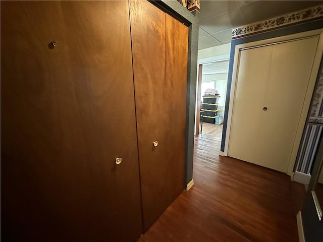 hallway with dark wood-type flooring