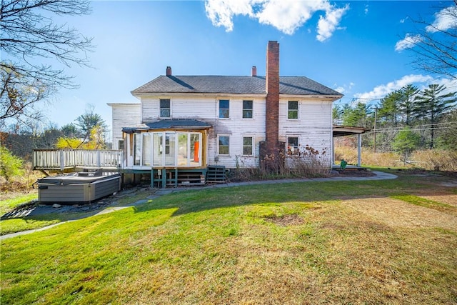 back of house with a deck and a yard