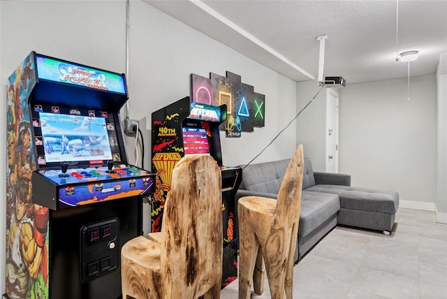 recreation room featuring a textured ceiling