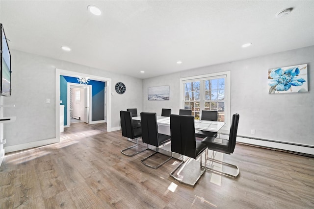 dining room featuring light wood-type flooring and baseboard heating